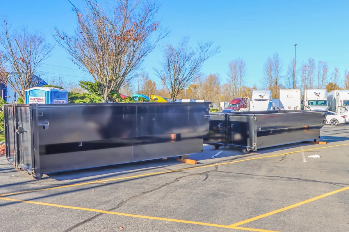 Professional dumpster rental service with roll-off container on residential driveway in Waupaca